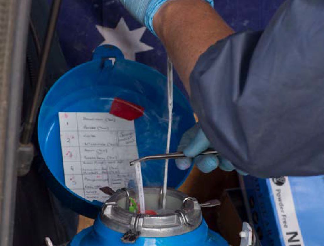 man in gloves with blue cannister